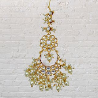 Polki Kundan Chand Shaped Tikka is a masterpiece of jewelry artistry.