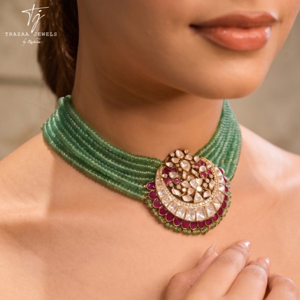 A multi-strand green beaded choker necklace featuring a central crescent-shaped pendant